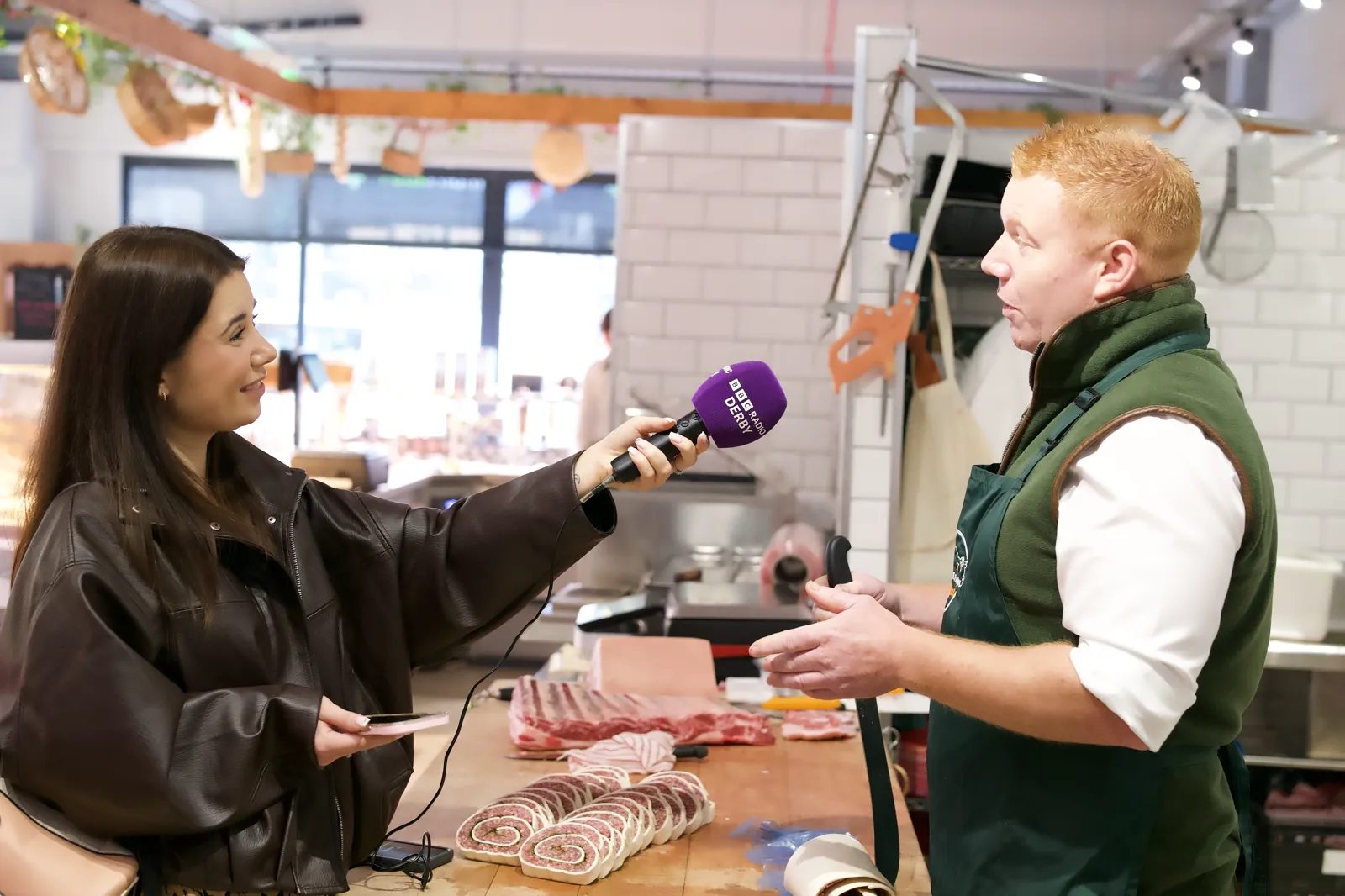 A BBC Radio Derby reporter interviewing Ed behind the counter