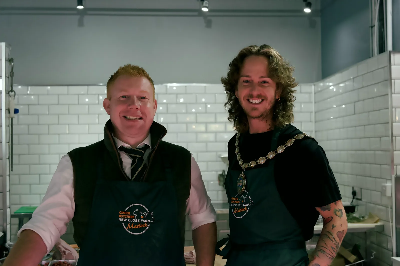 Ed from Ginger Butchers and the Mayor of Matlock smiling together behind the counter