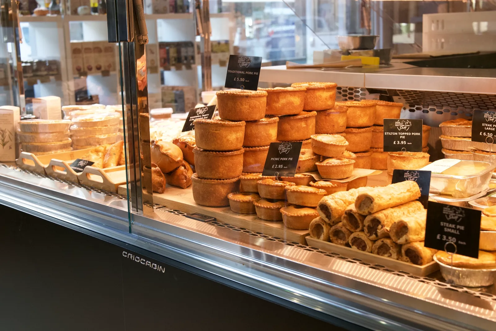 Rows of pork pies and sausage rolls on the Ginger Butchers counter