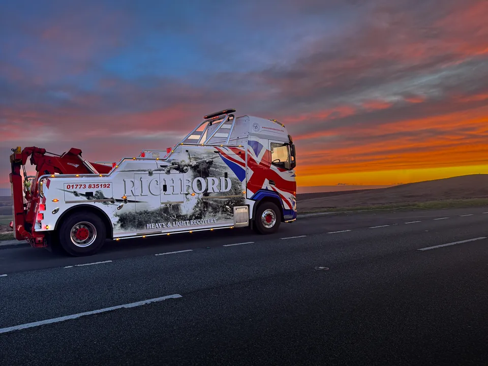 Richford Motor Services heavy recovery truck on the road at sunset